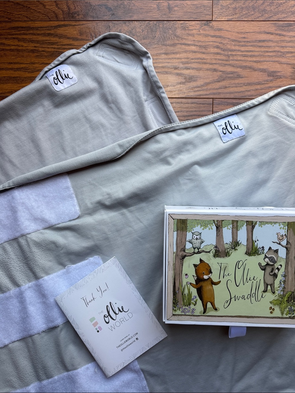 2 light grey Ollie Swaddles Baby
